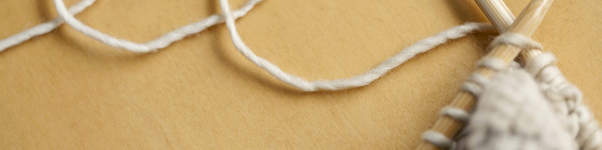 line of wool string connected to knitting project