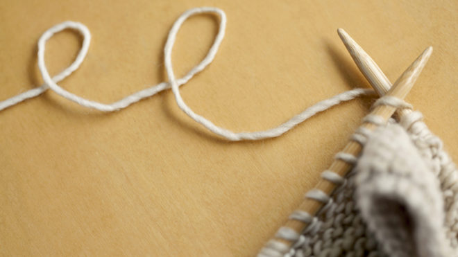 line of wool string connected to knitting project